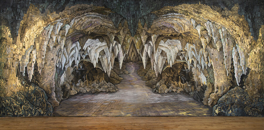 Large scale painting by Bev Pike depicting the interior of a cave with many stalactites.