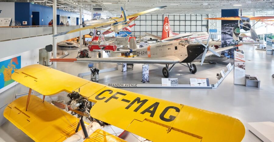 Photo inside of the aviation museum showing a number of small airplanes.