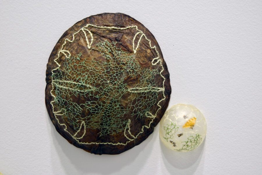 Artwork by Heather Komus. Two half dome shapes with embroidered designs.