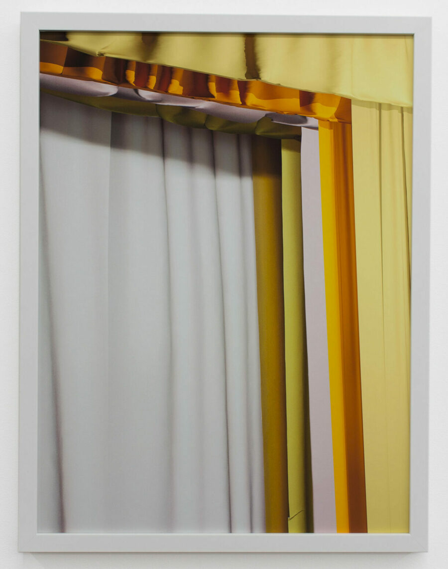 Photograph by Ashley Gillanders of overlapping white and yellow curtains.
