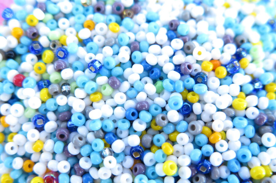 Close up picture of blue, white and yellow beads.