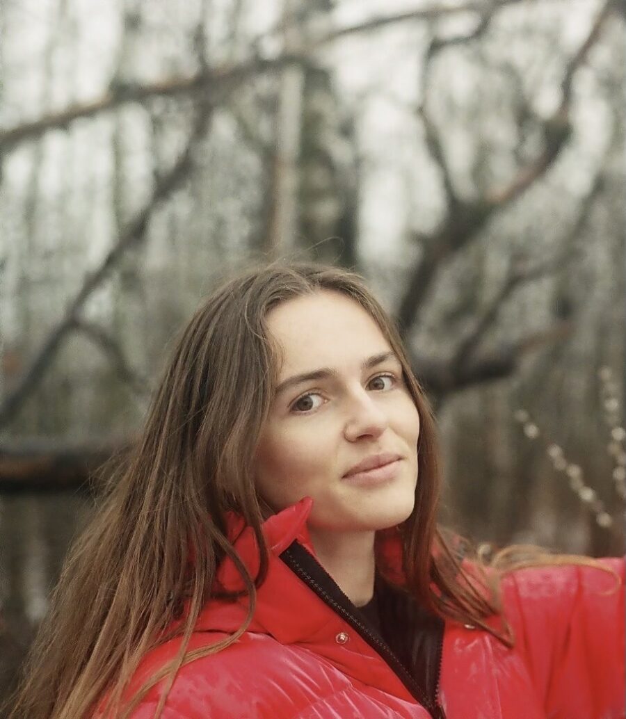 Picture of Claire Johnston outdoors wearing a red jacket.