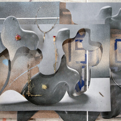 Collage by Alexis Dirks of grey smooth forms over a sandy texture and interspersed with branches.