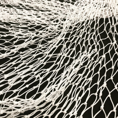 A net made of white string on a black background made by Kristin Nelson.