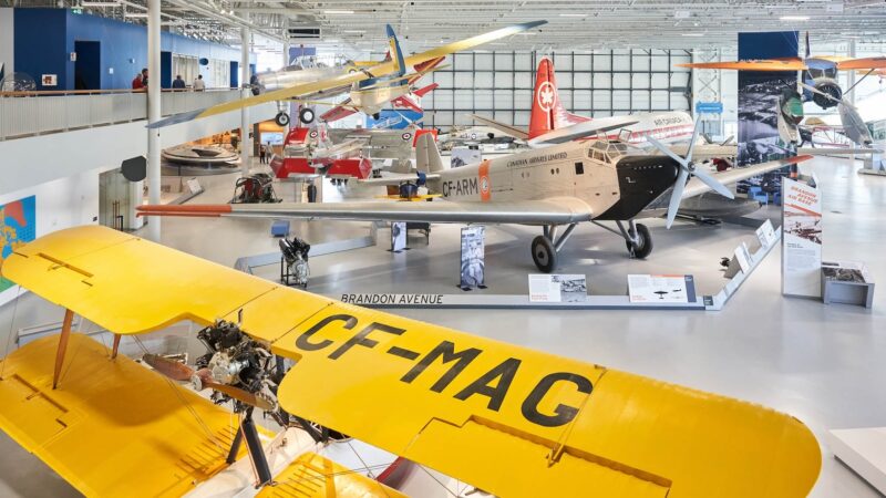 Photo inside of the aviation museum showing a number of small airplanes.