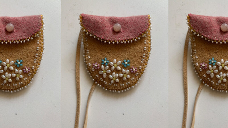 Three repeated images of a belly button bag by Candace Neumann. The bags are small, made with leather and have a folded over top and a simple beaded flower design.