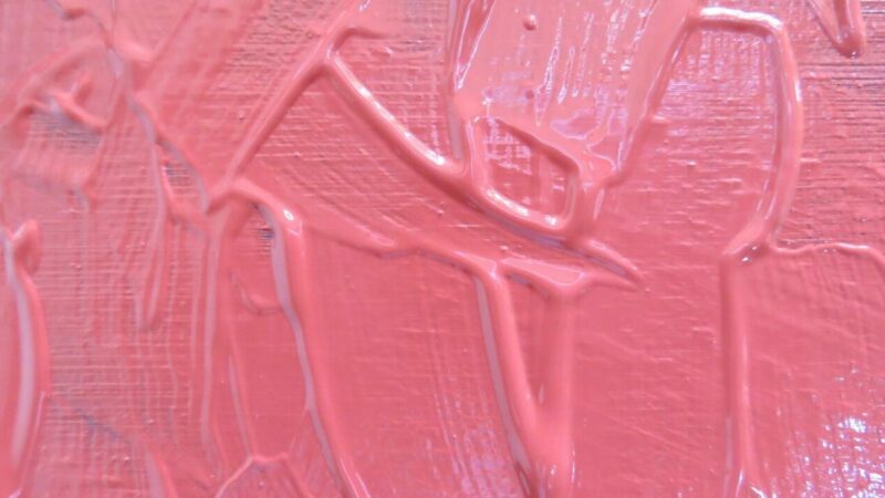Pink paint that shows lots of brush stroke texture.