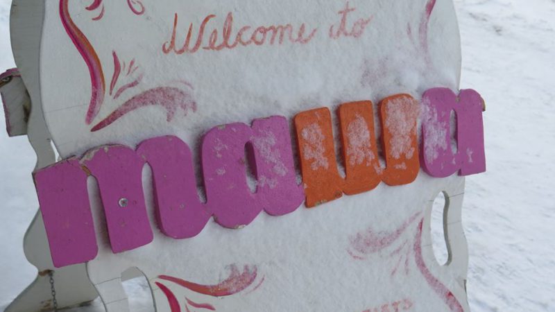 Exterior sandwich board sign with a dusting of snow reading Welcome To MAWA.